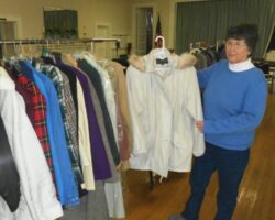 Cinni Cunningham organizes winter clothing for distribution at St Luke's Parish House.